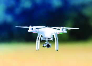 Flying drone, outdoor action on a defocused background. Royalty free image, no logos in the photo.